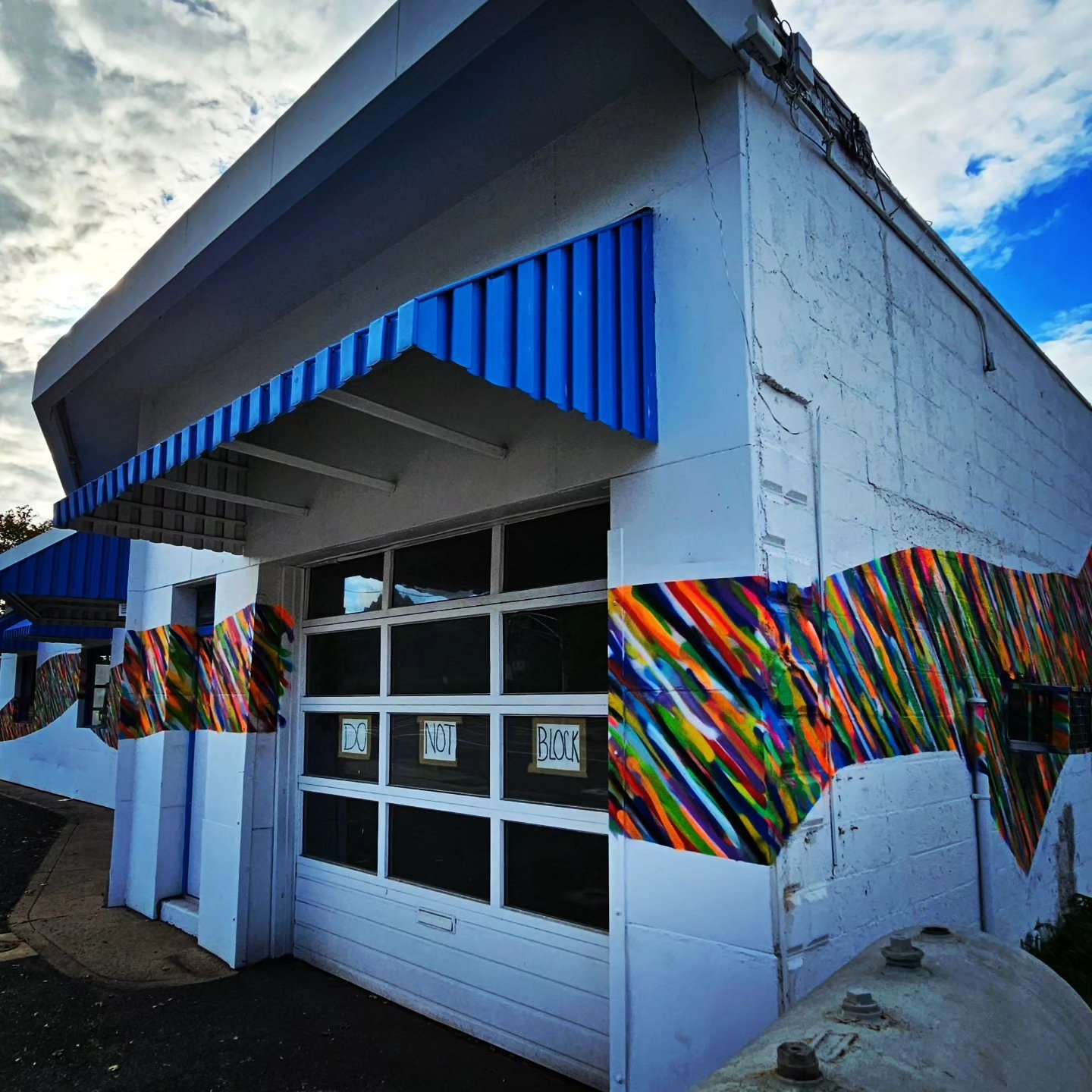 Da Race - corner building with mural and garage door